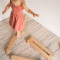 Toddler playing on wooden balance beams