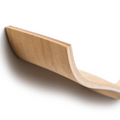Close-up of an ash wooden shelf with a smooth, cloud-like, curved edge, showing the refined, natural wood grain and texture.