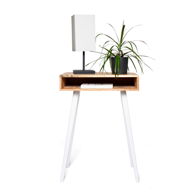 Front view of rectangular wooden nightstand with brass design and white wooden legs