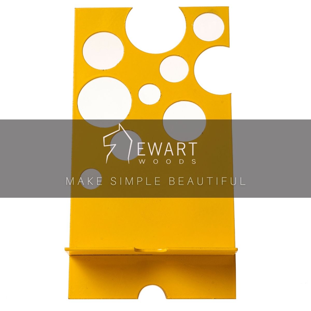 Yellow metal phone holder with circular cutout patterns, overlaid with the Ewart Woods logo and the slogan &