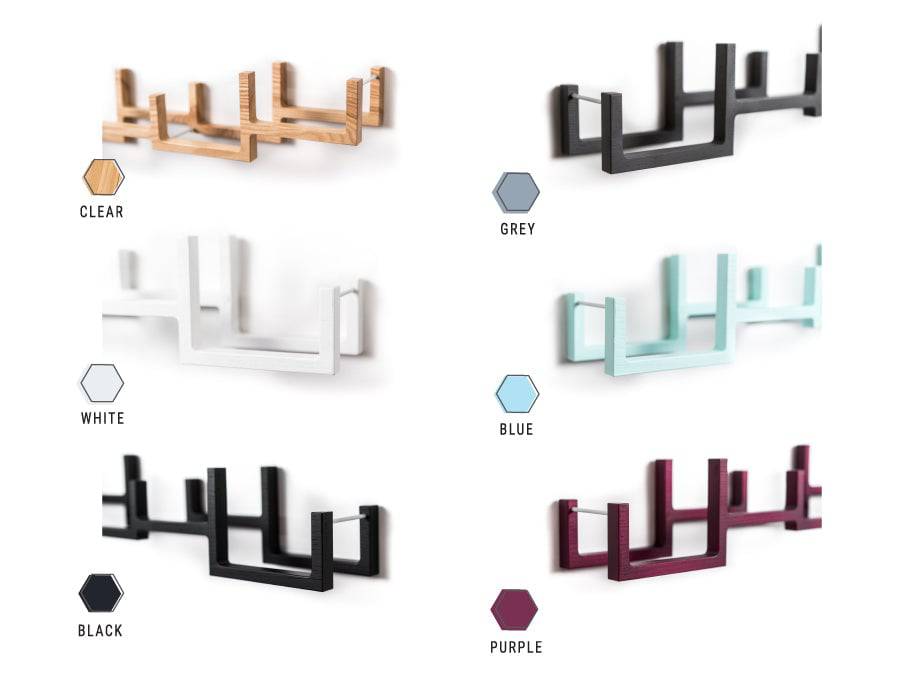 A selection of wooden wall-mounted toilet paper holders in different colors: Clear, Grey, White, Blue, Black, and Purple.