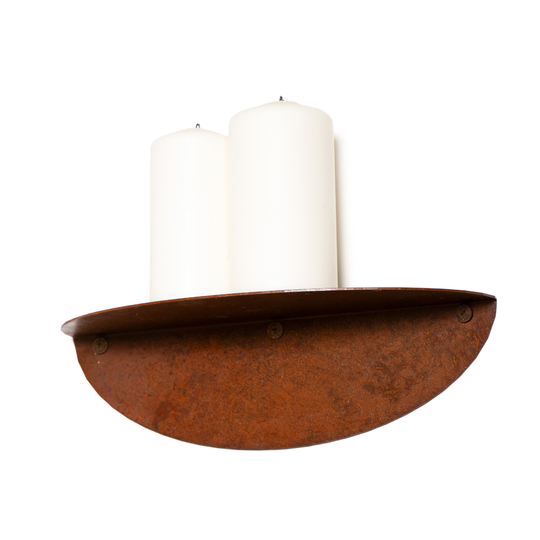 Single curved metal shelf with a rustic, oxidized finish, holding two white candles.