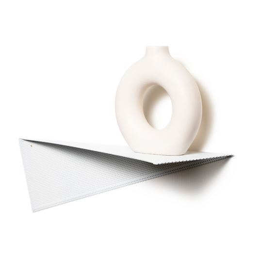 Perforated steel triangular wall shelf paired with a minimalist white ceramic vase, blending functional design with modern aesthetics.