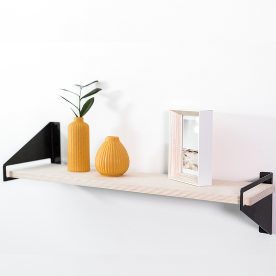 Wooden shelf with geometric metal brackets 