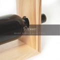 Close-up of small wooden wine and glass holder by EWART WOODS