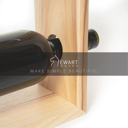 Close-up of small wooden wine and glass holder by EWART WOODS