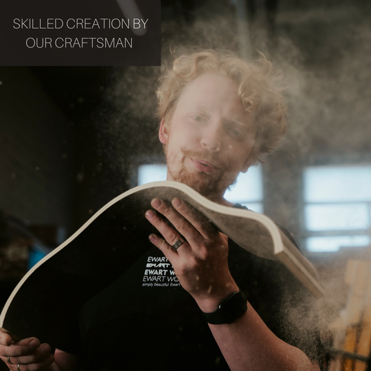 EWART WOODS craftsman holding wooden toilet paper holder in workshop