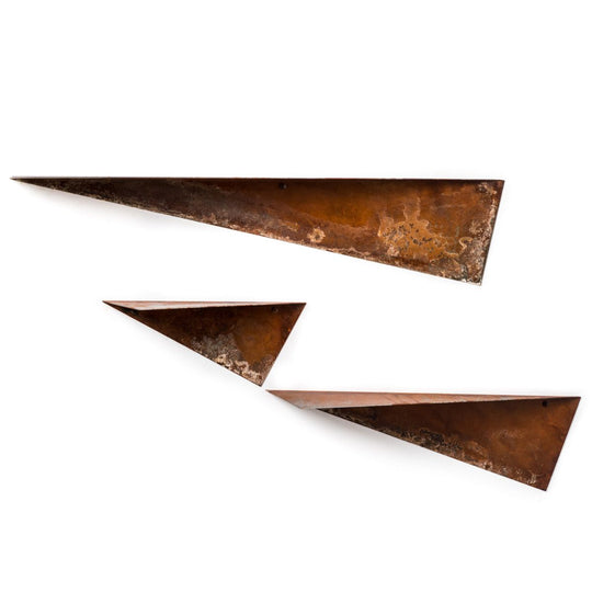 Three triangular metal shelves with a rustic, oxidized finish arranged in a staggered formation.