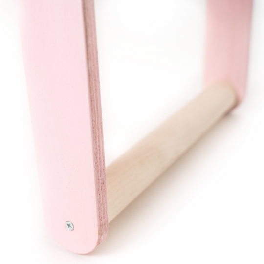 Close-up of the leg and smooth, natural wood support bar of a small children&
