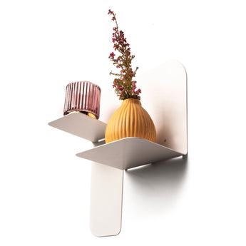White floating metal shelf with dual level structure, crafted from durable steel. Secured with visible fasteners, it displays a ribbed glass candle holder and an orange vase with flowers.