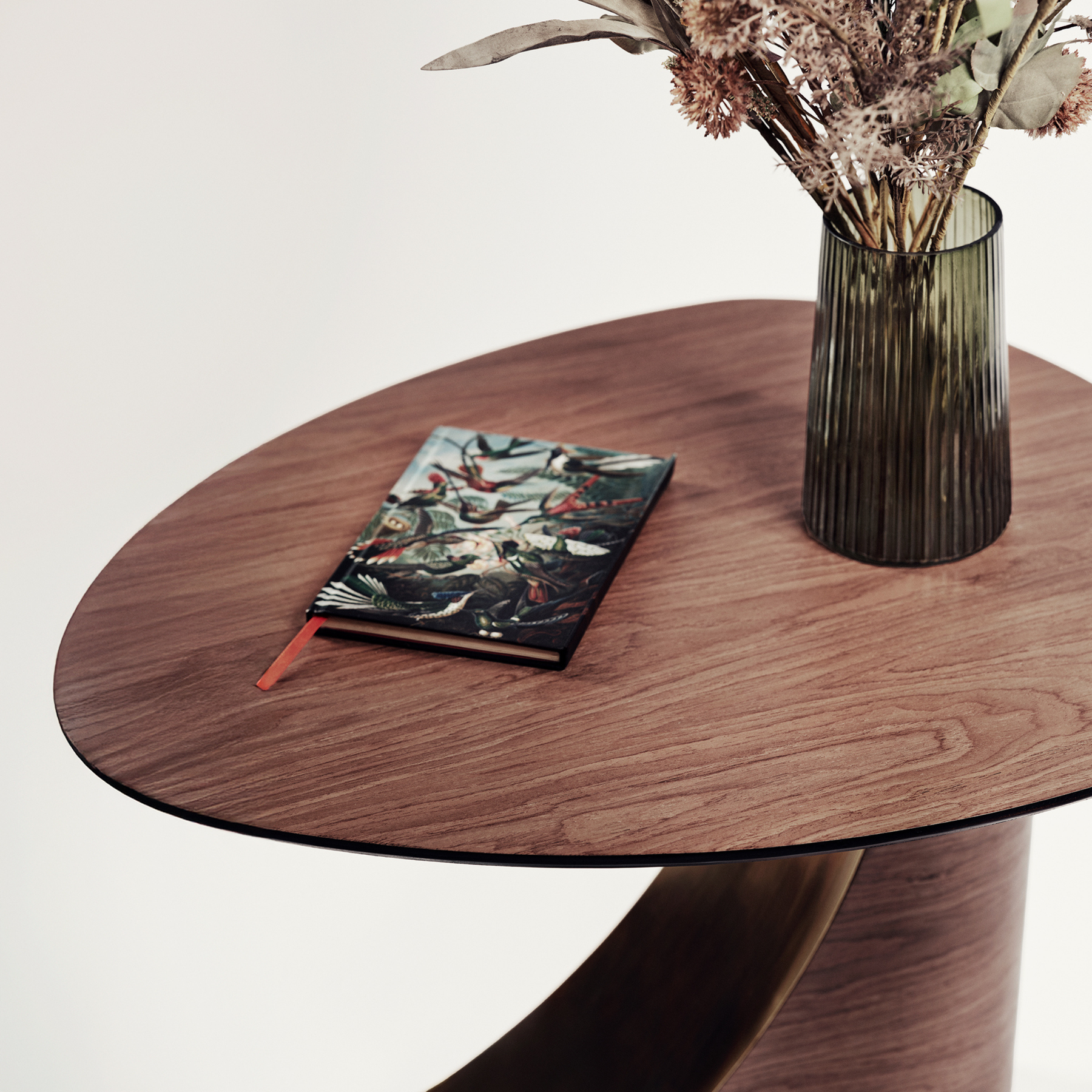 Close up of modern round wooden coffee table with brass design on the wooden base