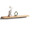 Minimalist wooden shelf with a torso-shaped vase holding flowers and a circular green ceramic object. The shelf has a natural wood finish.