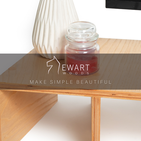 Wooden monitor stand with compartments featuring EWART WOODS branding