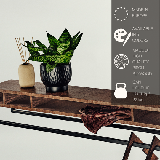 A modern console table with a warm brown wood finish and black metal frame, styled with a potted snake plant and a diffuser. A dark gray text panel on the right lists product features in English.