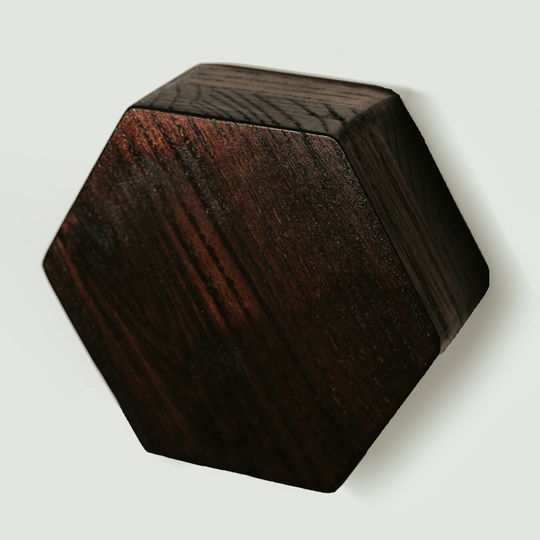 Hexagonal wooden key holder with a natural wood grain pattern, stained in dark brown color. 
