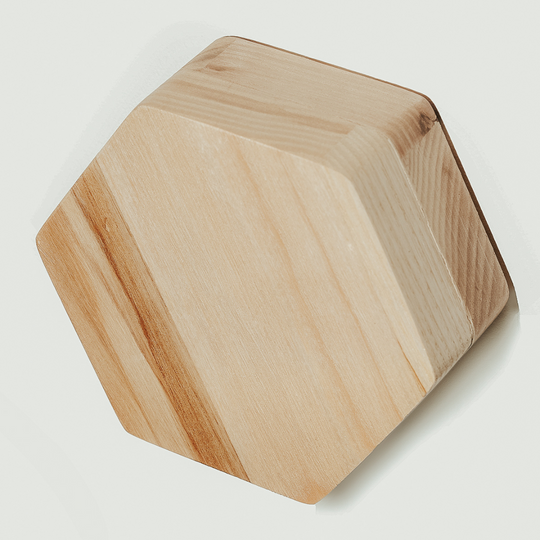 Hexagonal wooden key holder with a natural wood grain pattern, featuring a minimalist style and durable wood material.