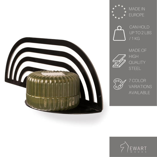 Metal wall-mounted shelf with an arched design holding a small rounded container. Text beside it mentions Made in Europe, can hold up to 1 kg, made of high-quality steel, and 7 color variations available. Brand: Ewart Woods.