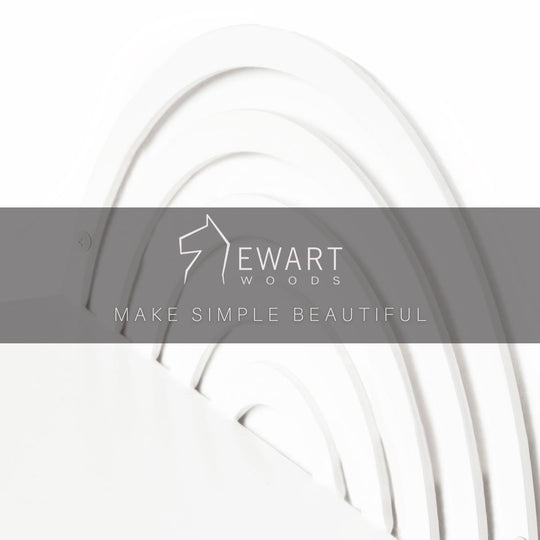 Close-up of a white, semi-circular metal shelf with a concentric, arched pattern. 