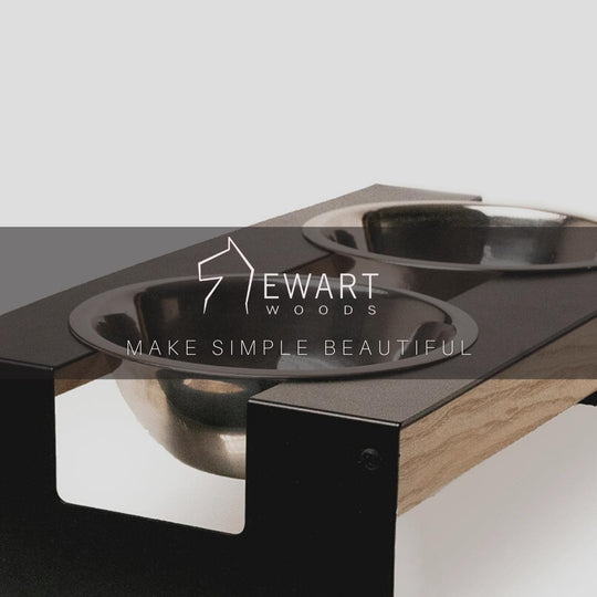 Stainless steel dog bowls set in a powder-coated metal frame with smooth, natural wood accents, providing a refined and elegant look.