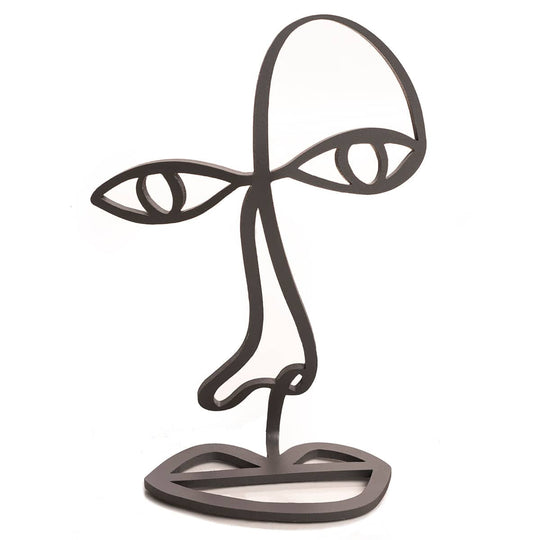 Modern black metal sculpture in an abstract face design, featuring outlined eyes, nose, and lips in a sleek wireframe style. The sculpture serves as a decorative glasses holder, with the top section shaped to rest eyewear over the eye area.