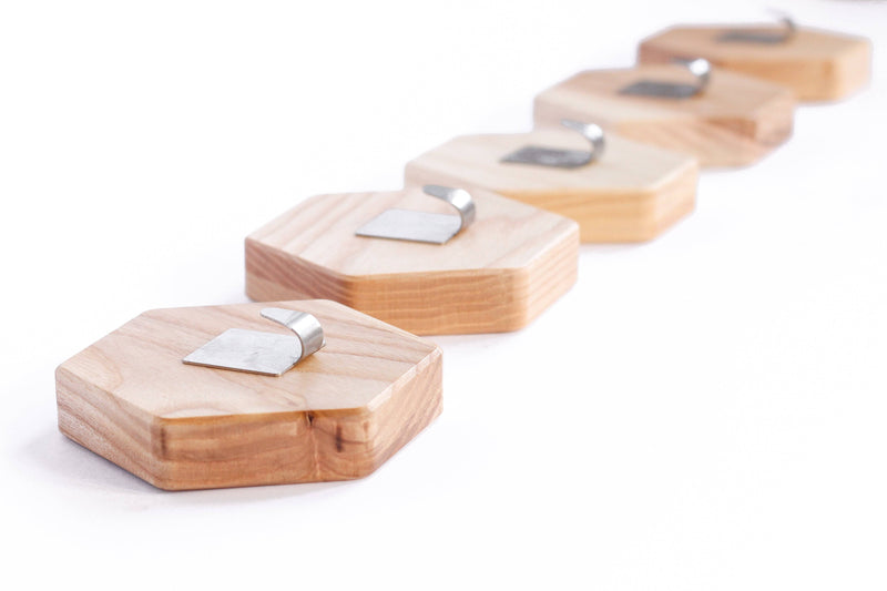 Hexagonal wooden wall hook mounted in bathroom as towel holder and coat hanger