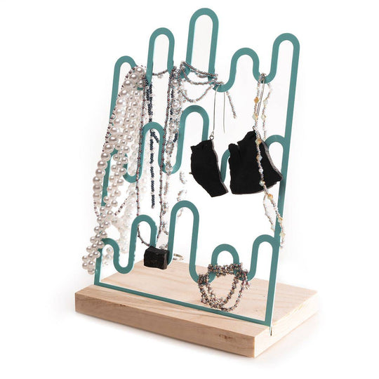 Teal metal jewelry holder with a unique wave-like shape and a wooden base, displaying necklaces and earrings.