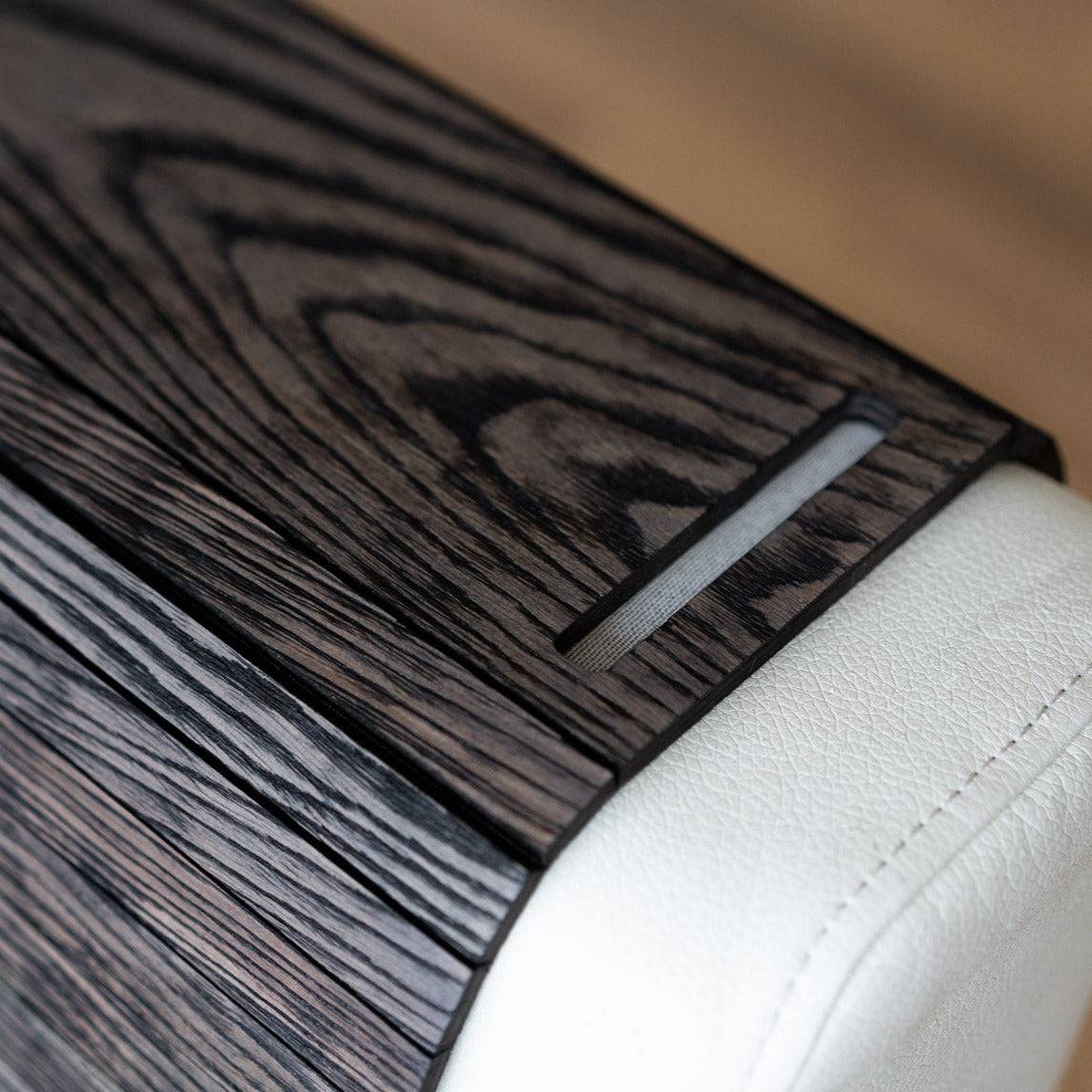 Burned Wooden Sofa Arm Tray Table on a couch arm, showcasing its versatility and stylish burnt wood finish. EWART WOODS