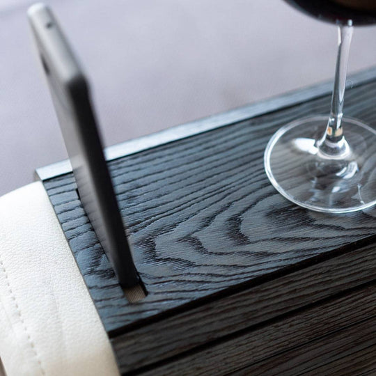 Burned Wooden Sofa Arm Tray Table on a couch arm, showcasing its versatility and stylish burnt wood finish. EWART WOODS