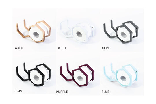 A variety of mini honeycomb toilet paper holders in different colors: wood, white, gray, black, purple, and blue.