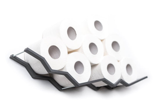 Wall-mounted gray zigzag toilet paper holder, displaying eight rolls arranged in a dynamic zigzag pattern.
